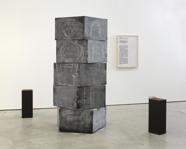 Clegg & Guttmann’s interactive sculpture Continuous Drawing/Exquisite Corpse, a wooden pentagonal column, painted as a blackboard, with five horizontally revolving layers