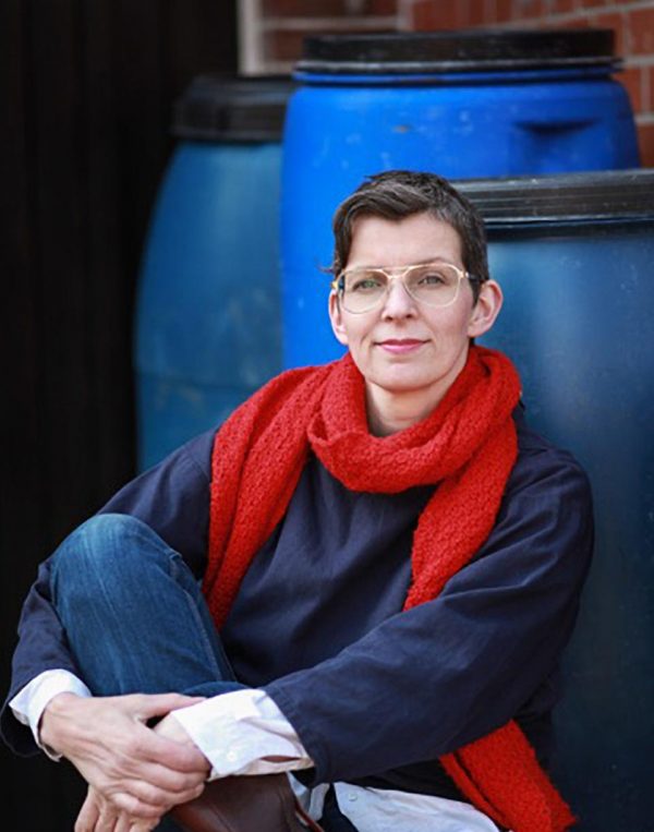 Artist Kathrin Bohm posing for a portrait picture in red scarf