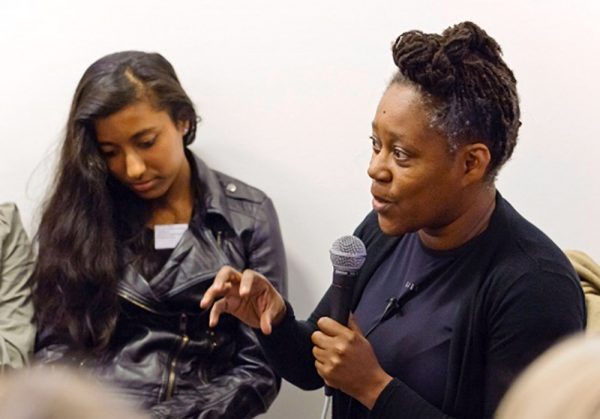 Artist Sonia Boyce talking to a group of people on a microphone
