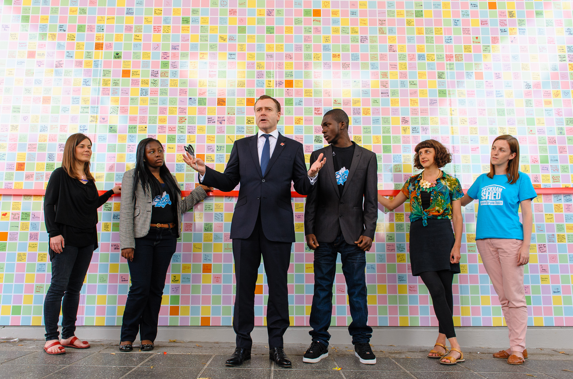 image of a group of people standing in front of the Peckham Peace Wall
