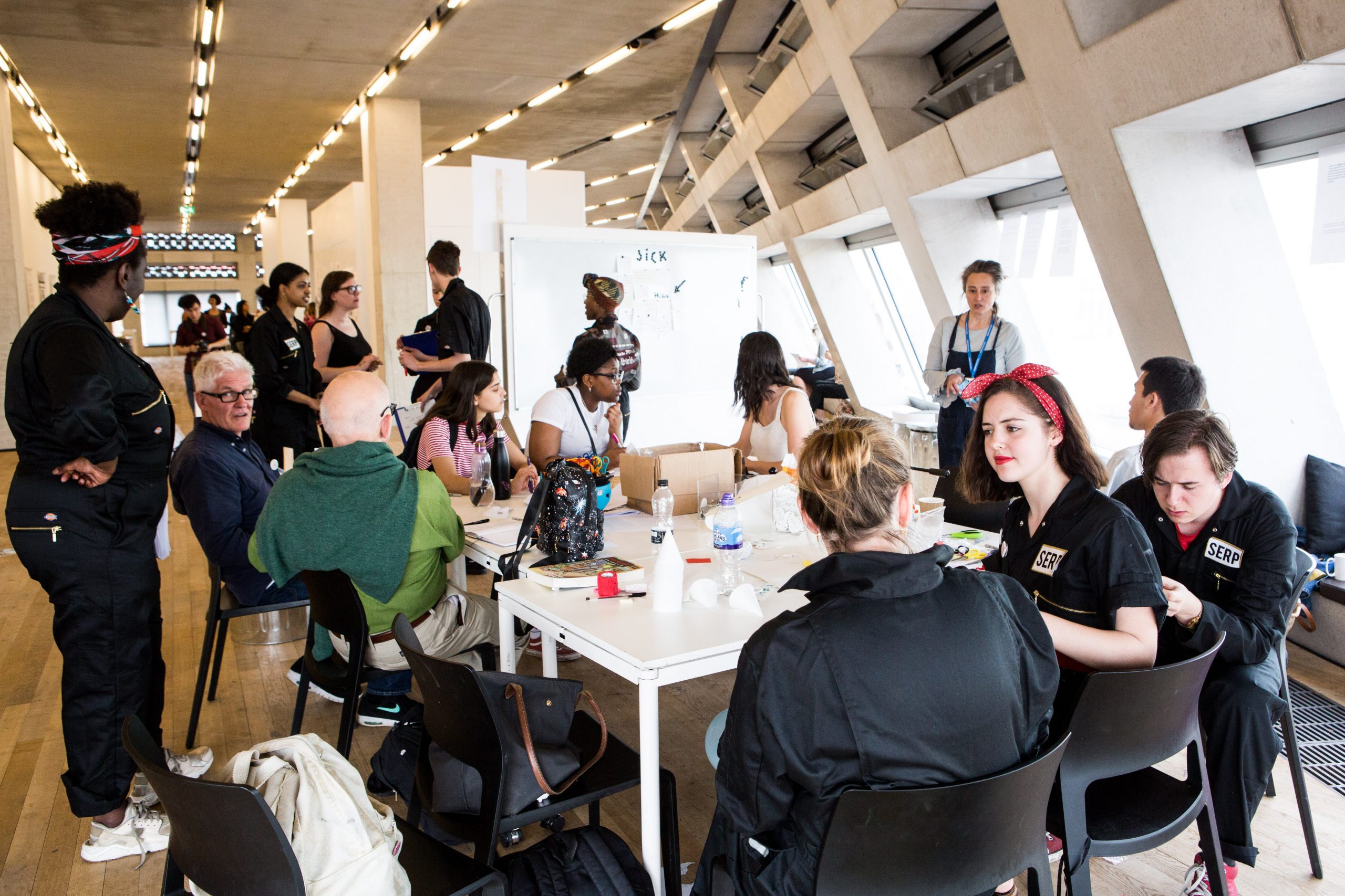 image of a group of people taking part in an art session around a table with Peckham Platforme